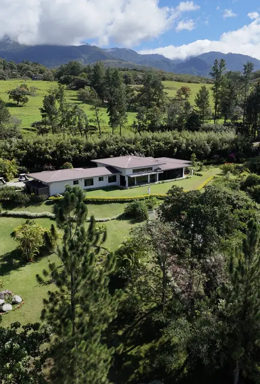 A Lucero custom-built home with surrounding gardens and mountain views